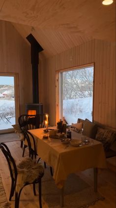 a dining room with a table and chairs next to an open fire place