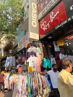 a man standing in front of a clothing store