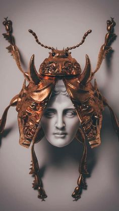 the head of a woman with horns on it's head is made out of gold