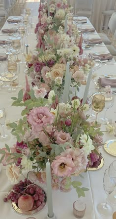 a long table with flowers and candles on it