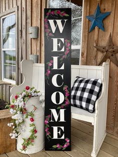 a welcome sign sitting next to a white bench