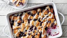 a blueberry cobbler in a white casserole dish with the words, a big hit with everyone