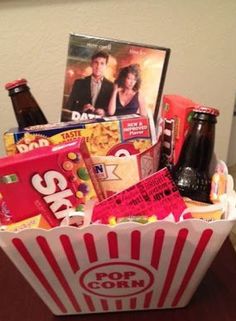 a popcorn bucket filled with movies and snacks