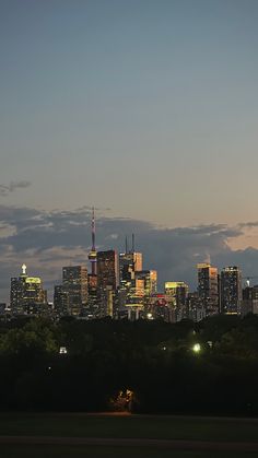 the city skyline is lit up at night