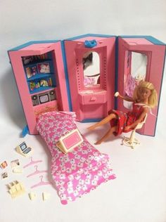 a barbie doll plays with her bedroom furniture