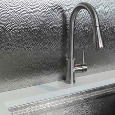 a stainless steel sink and faucet in a kitchen