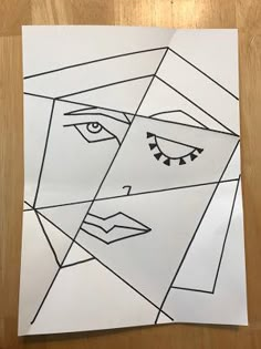 a piece of paper with an image of a woman's face drawn on it