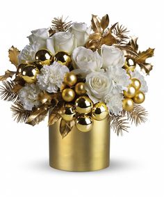 a gold vase filled with white and gold flowers