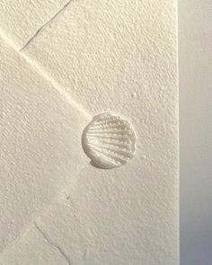 a white envelope with a seashell on it