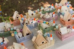 many small wooden houses and birds on a table