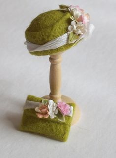 a small green hat with flowers on it