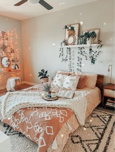 a bedroom decorated with lights and plants on the wall above the bed, along with other decorations