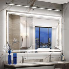 a bathroom with a large mirror over the sink