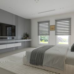 a large bed sitting in a bedroom next to two windows with blind shades on them