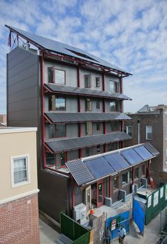 an apartment building with solar panels on the roof