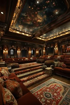 an ornately decorated home theater with red couches and rugs on the floor