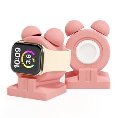 a pink apple watch stand with an alarm clock on it's side and two smaller ones in the middle