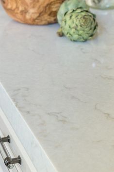 a kitchen counter top with an artichoke and other items on the countertop