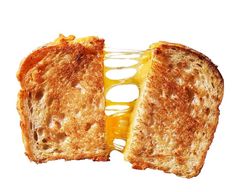 a grilled cheese sandwich cut in half on a white background with one slice missing