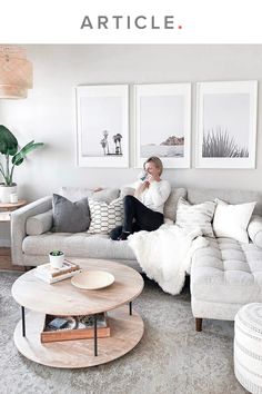 a woman sitting on top of a couch in a living room