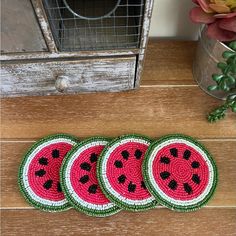 four watermelon coasters sitting on top of a wooden table