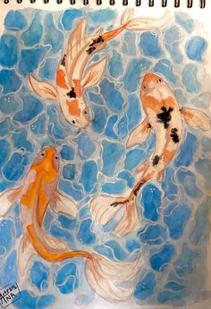 two orange and white koi fish swimming in blue water with bubbles on the surface