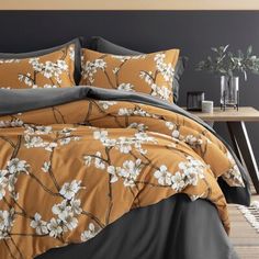 an orange and black bed with white flowers on it