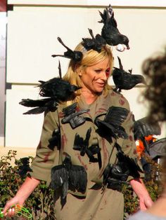 a woman with many birds on her head