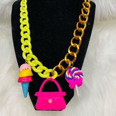 “Jewelry Is Like Ice Cream, There’s Always Room For More”. So We Bring You This Beautiful Handmade Barbie Themed Necklace. It Features Multiple Charms From A Authentic Pink Barbie Purse To A Three Tier Ice Cream Cone. This Piece Has Two Colors For The Chain, Lime Green And Gold. This Necklace Is Definitely A Eye Catcher And Conversational Piece. Trendy Party Charm Necklace, Trendy Party Charm Necklace With Chain, Trendy Party Charm Necklaces With Chain, Trendy Charms Necklaces For Party, Trendy Party Necklaces With Charms, Trendy Party Necklace With Lobster Clasp, Trendy Party Charm Necklaces, Trendy Charm Necklaces For Party, Pink Metal Jewelry As Fashion Accessory