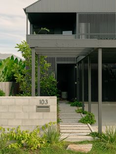 an apartment building with stairs leading up to the front door and number on the wall