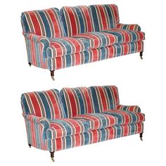 two red, white and blue striped couches with wooden legs on each side are facing different directions