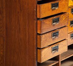 an old wooden cabinet with drawers and numbers on it