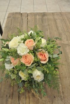 a bouquet of flowers sitting on top of a wooden table