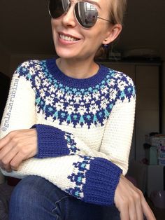 a woman wearing sunglasses sitting on top of a couch