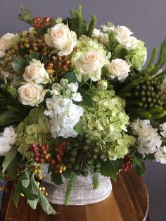 a vase filled with white and green flowers