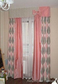 a living room with pink curtains and a chandelier