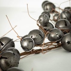 some metal bells that are sitting on top of each other, and tied together with twine