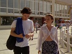 a man and woman walking down the street