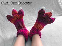 a woman's legs wearing pink and red knitted mittens