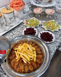 a table topped with lots of food on top of a counter