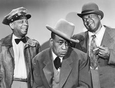 three men in suits and hats posing for the camera