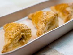 three pastries sitting in a pan on a table