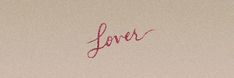 a piece of paper with the word love written in red ink on top of it