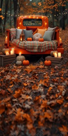 a truck bed with candles on it in the middle of leaves and lights around it