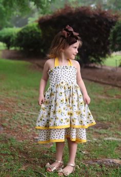 Sweet Sunflower and Bee dress! Perfect for Summer photos or picnics.  This darling dress has a double skirt with bees and sunflowers.  A bright yellow trim highlights the skirts.  The halter ties at the neck.  This dress runs a little big. Please make sure to check chest measurements below. 6-12 month18" 12-18 month19" 2t20" 3t21" 4t22" 5t23" 624" 725" 826" Sunflower And Bee, Summer Halter Dress, Halter Dress Summer, Sunflower Dress, Bee Dress, Yellow Trim, Darling Dress, Dress Girls, Summer Photos