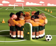 a group of people hugging each other in front of a soccer field