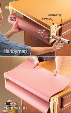 a man is working on a desk with pink paper