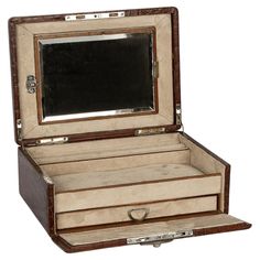 an open wooden box with a mirror on it's lid and drawers in the bottom