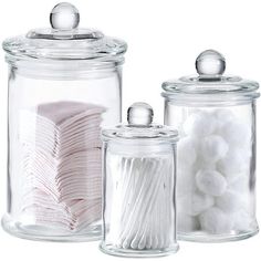 three glass jars filled with white and pink items on top of each other in front of a white background