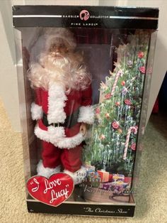 a christmas ornament in a box with a santa clause on it's chest